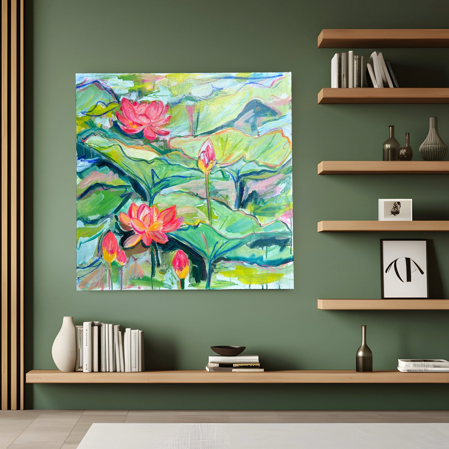 Original painting titled 'Colorful Lily Pad Bliss' by Natalie Russo displayed on a green wall above a minimalist wooden shelf with books and decorative items. The vibrant artwork features colorful lily pads and bright pink lotus flowers, adding a lively and nature-inspired touch to the modern, stylish interior.