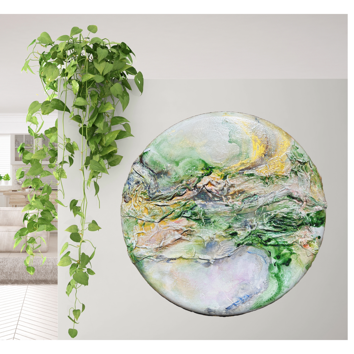 A textured abstract painting on a round canvas, displayed on a white wall beside a hanging green pothos plant. The painting features a blend of green, yellow, and white colors with dynamic textures and swirls, evoking a natural, earthy feel. The organic lines and forms within the artwork complement the trailing leaves of the pothos, enhancing the peaceful and artistic ambiance of the space.